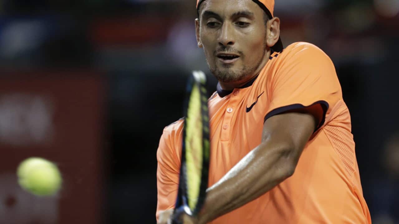 Nick Kyrgios of Australia hits a return