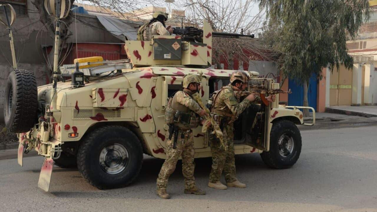 Afghan army soldiers take positions near an office of the British charity Save the Children during an ongoing attack in Jalalabad on January 24, 2018.