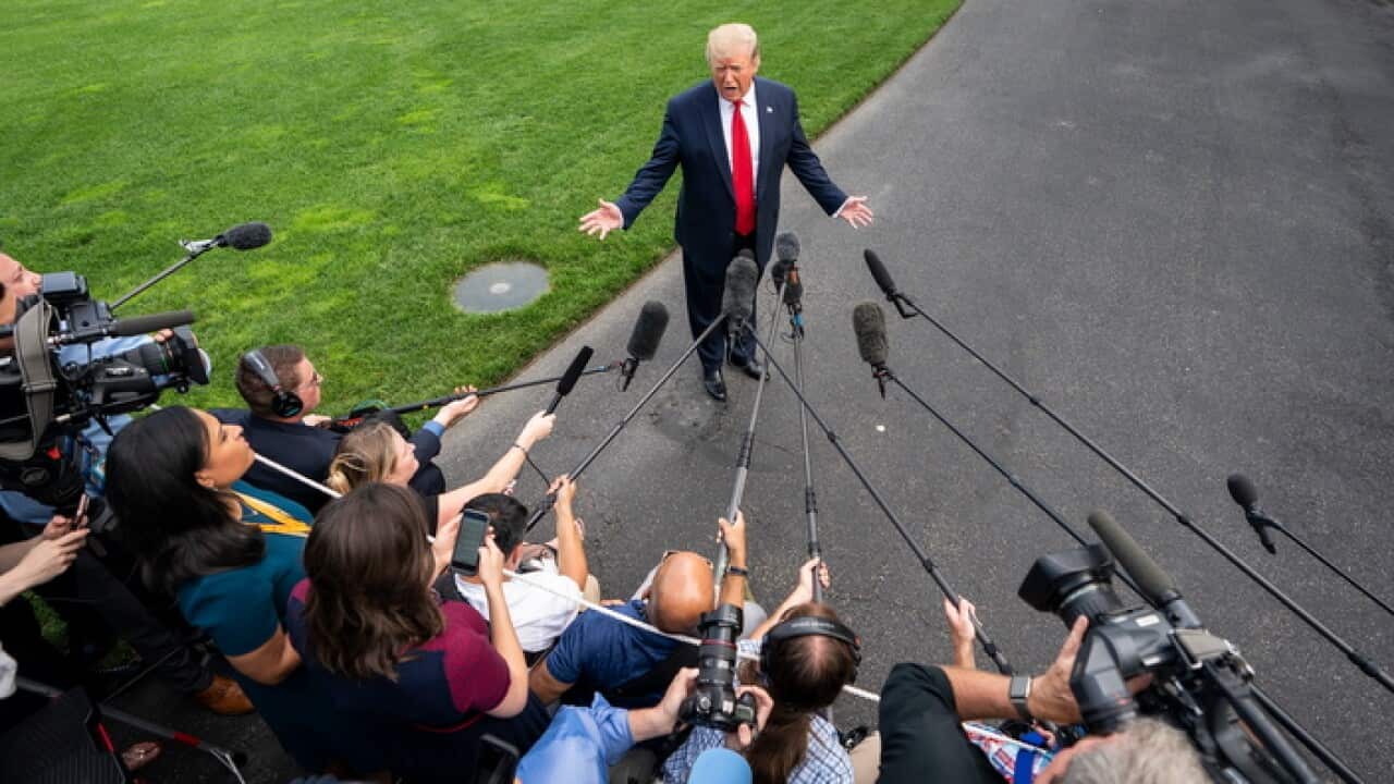 US President Donald J. Trump speaks to the media as he departs the White House