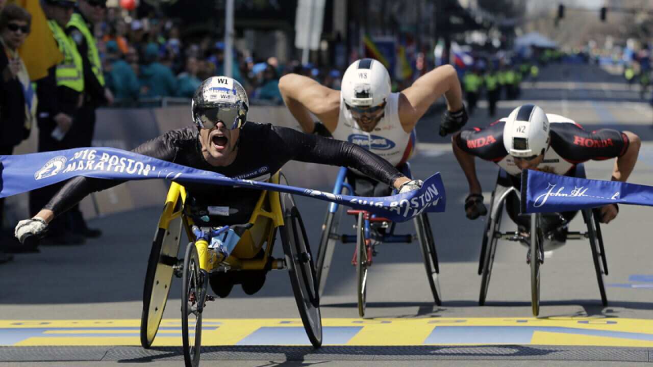 Kurt Fearnley (C) finishes the the 120th Boston Marathon