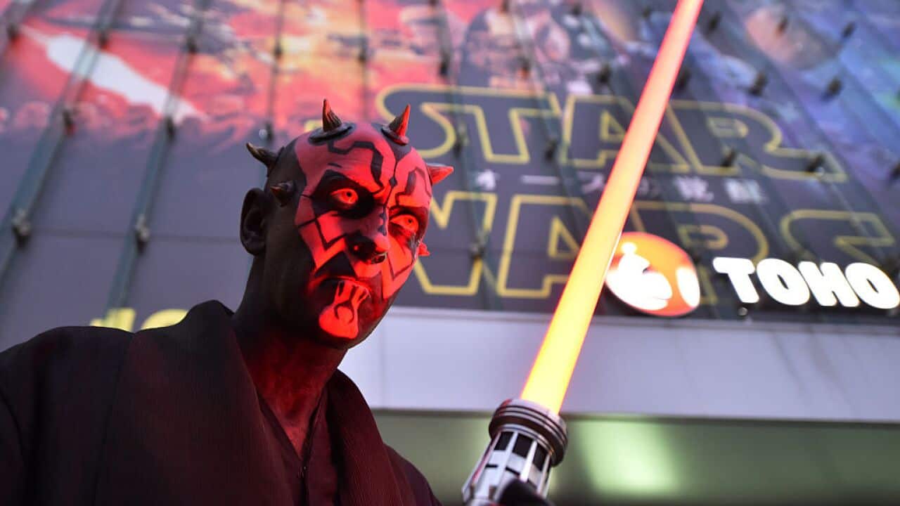 A fan dressed as a Star Wars character celebrates the opening of Star Wars: The Force Awakens in Tokyo