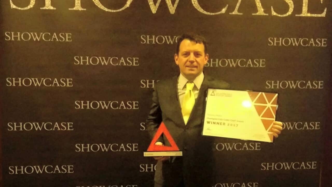 Roberto Mattei holding an award and a certificate.