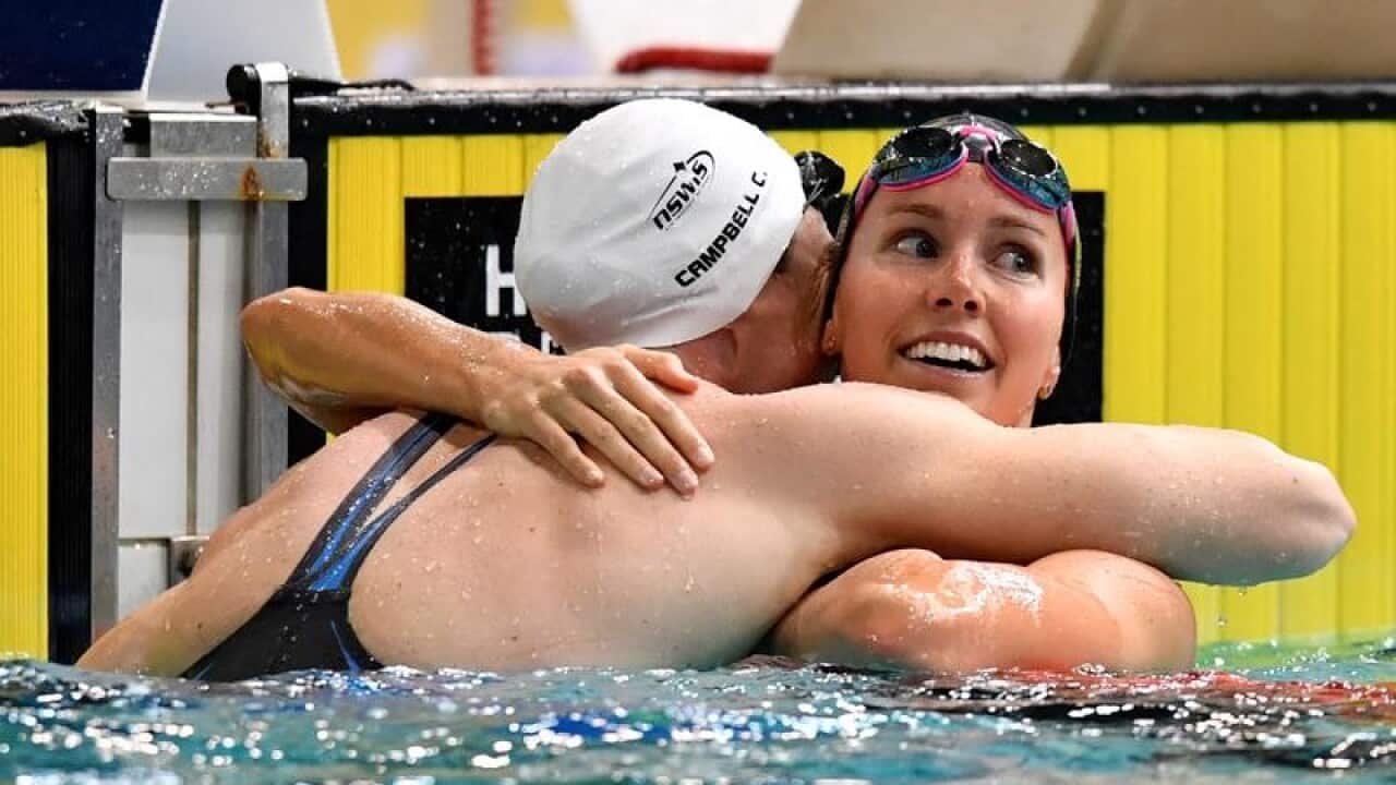 Cate Campbell (l) hugs Emma McKeon after the final of the women's 100m freestyle at the world trials.