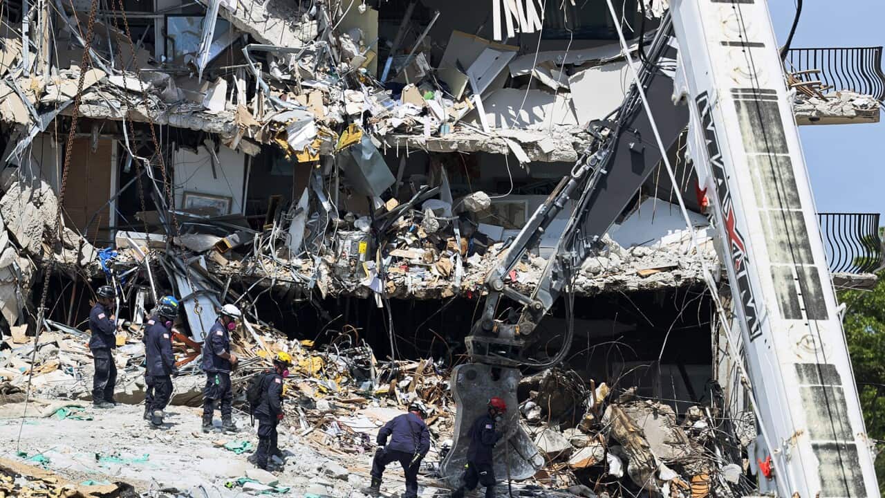 Search and rescue personnel search for survivors through the rubble at the Champlain Towers South Condo in Surfside, Florida, Sunday, June 27, 2021.