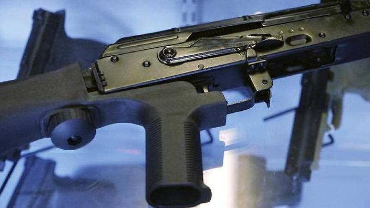 A little-known device called a bump stock is attached to a semi-automatic rifle at the Gun Vault store and shooting range Wednesday