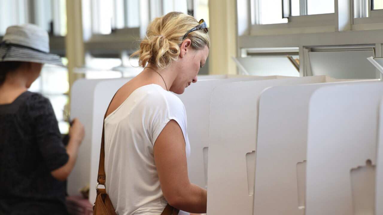 A voter casts her ballot