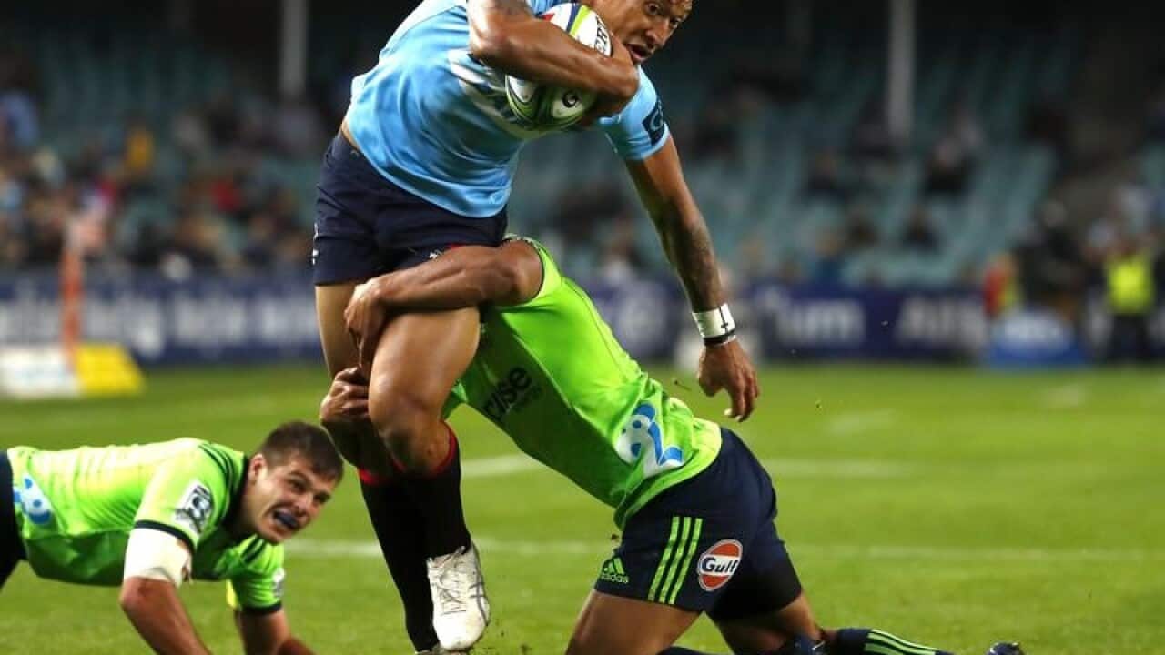 Israel Folau of the Waratahs is tackled