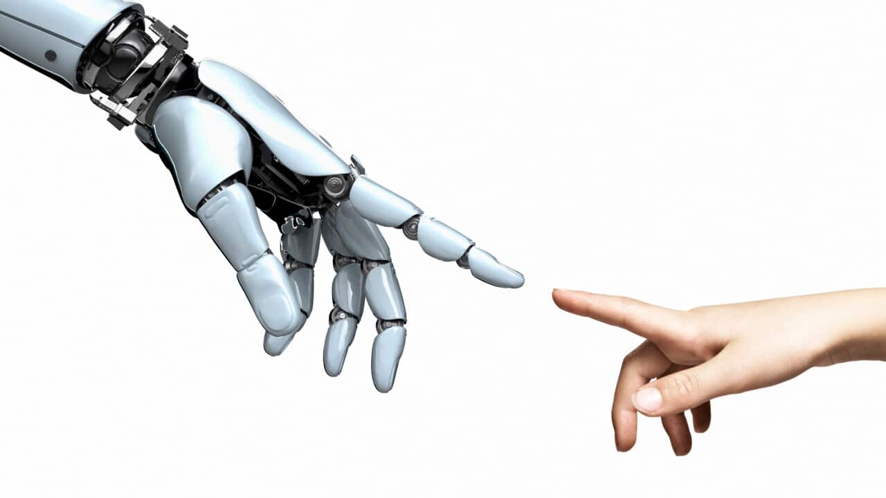 robot hand and child's hand pointing fingertips