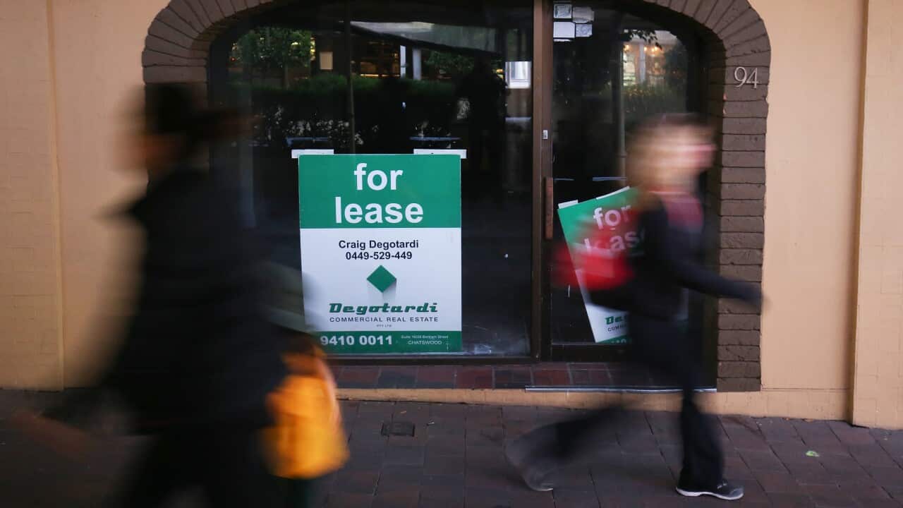 Pedestrians walk past a closed shop in the suburb of Crows Nest in Sydney,