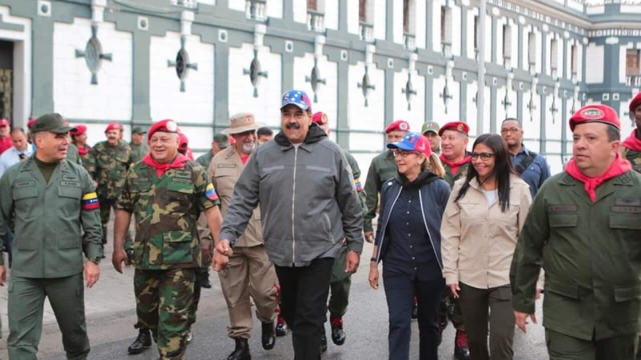 President Maduro wa;ks with the military in a show of strength