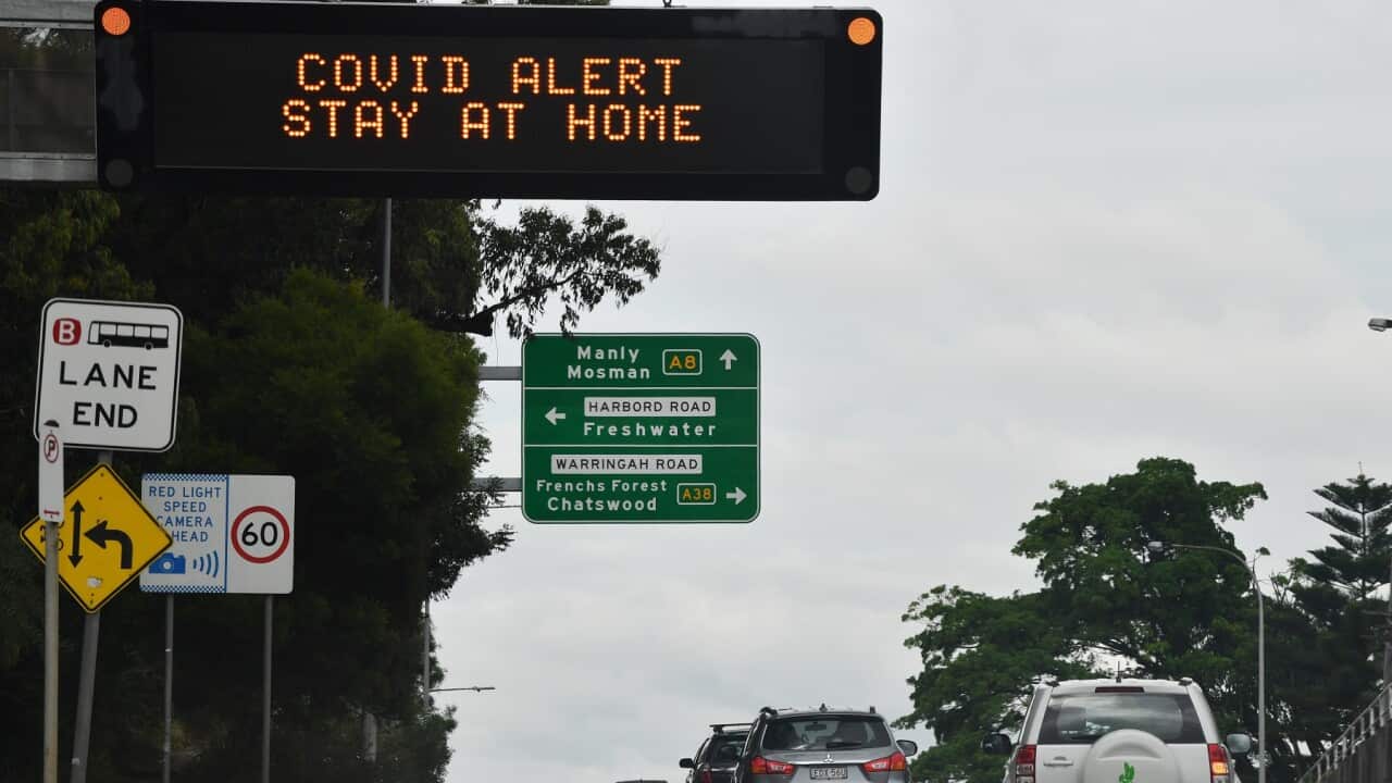 A sign on Pittwater Road instructs residents and visitors to stay home in the northern beaches of Sydney