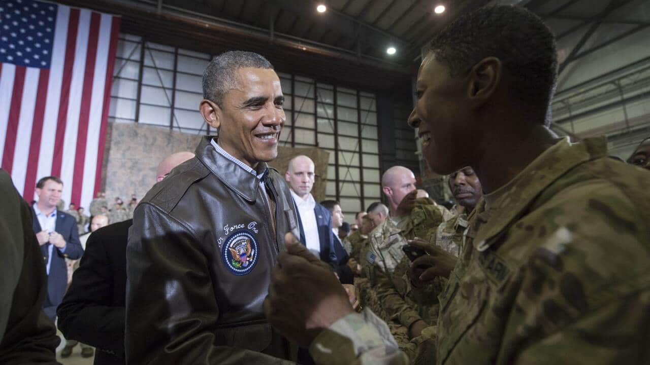 US President Barack Obama greets US troops during a surprise visit to at Bagram Air Field, north of Kabul, in Afghanistan, May 25, 2014, prior to the Memorial Day holiday. (AFP)