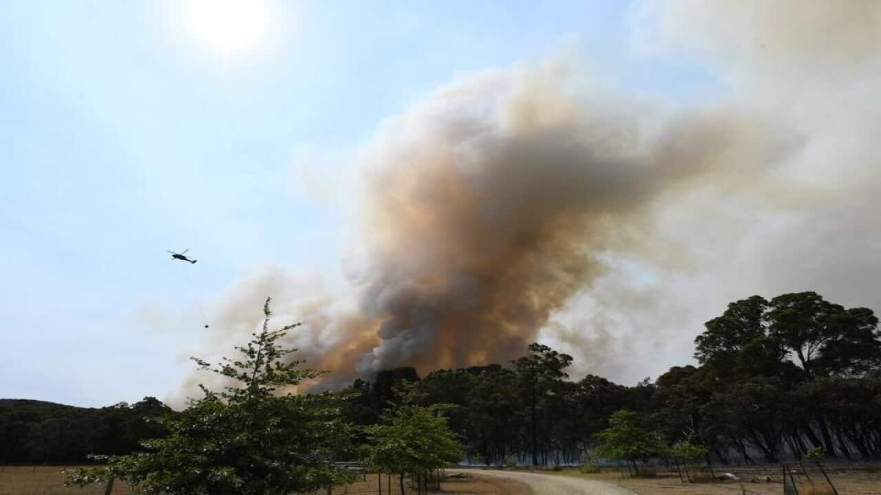 water bombing helicopter over bushfire smoke in Victoria