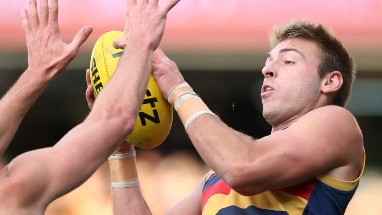 Daniel Talia of the Crows takes a mark