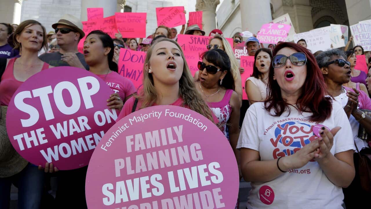Planned Parenthood supporters rally for women's access to reproductive health care on "National Pink Out Day'' at Los Angeles City Hall.