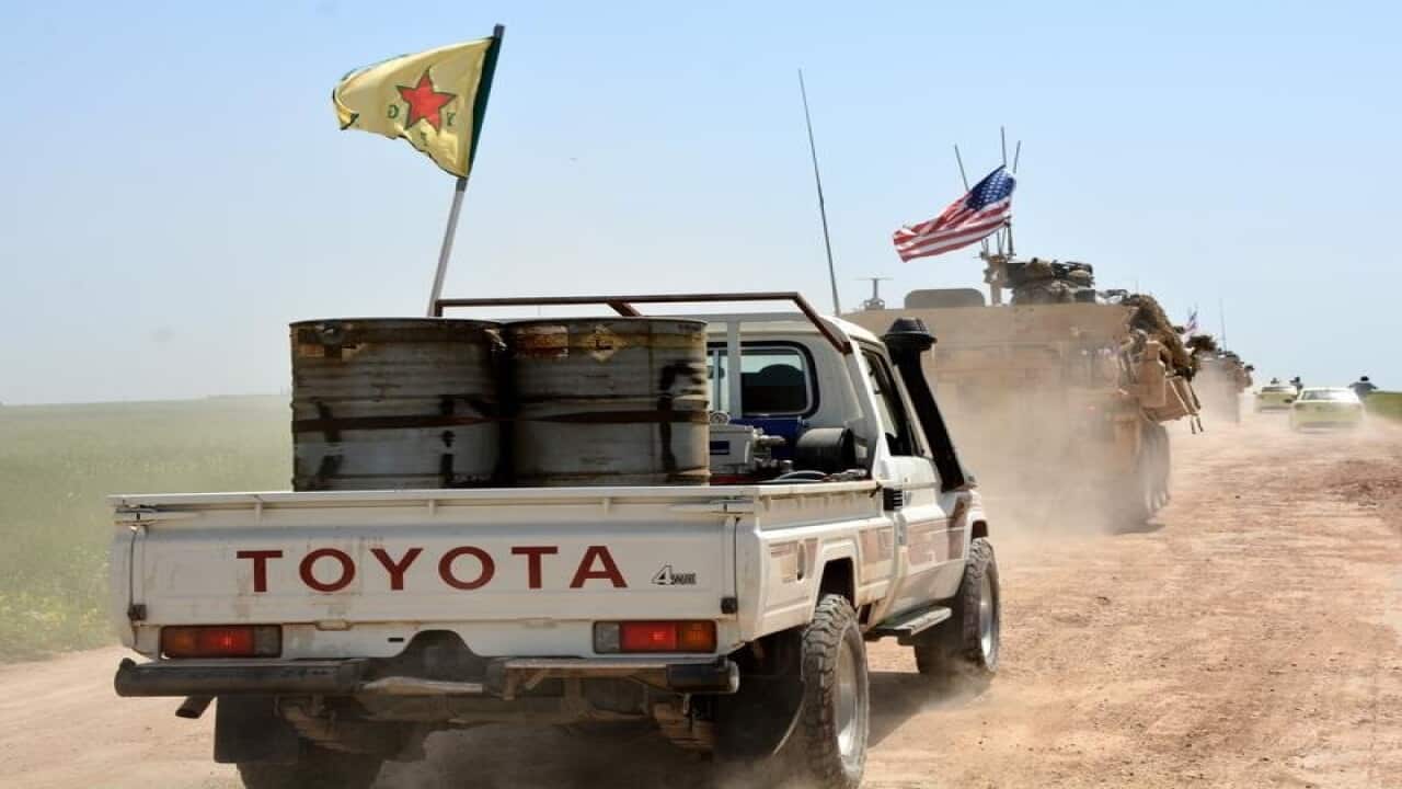 A convoy of YPG and US trucks