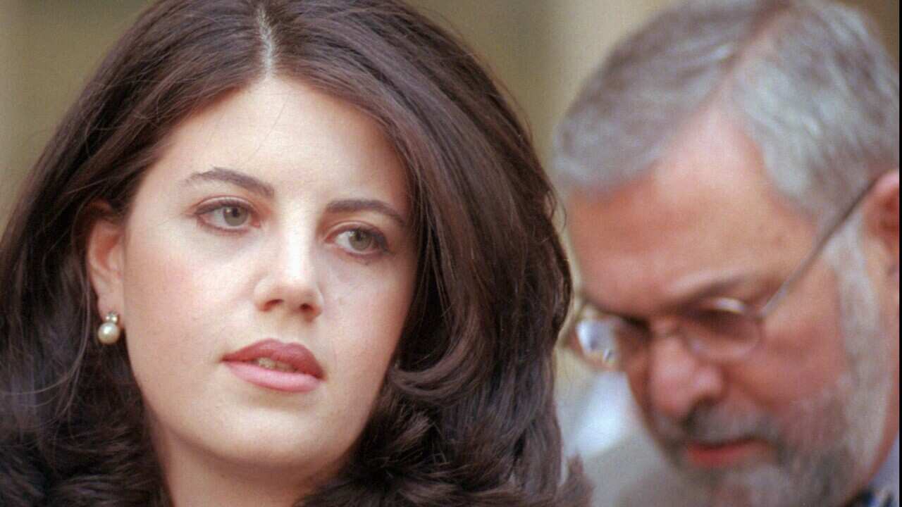 Former White House intern Monica Lewinsky and her attorney William Ginsburg head to their car from the Wanamaker Building in Philadelphia April 6, 1998.