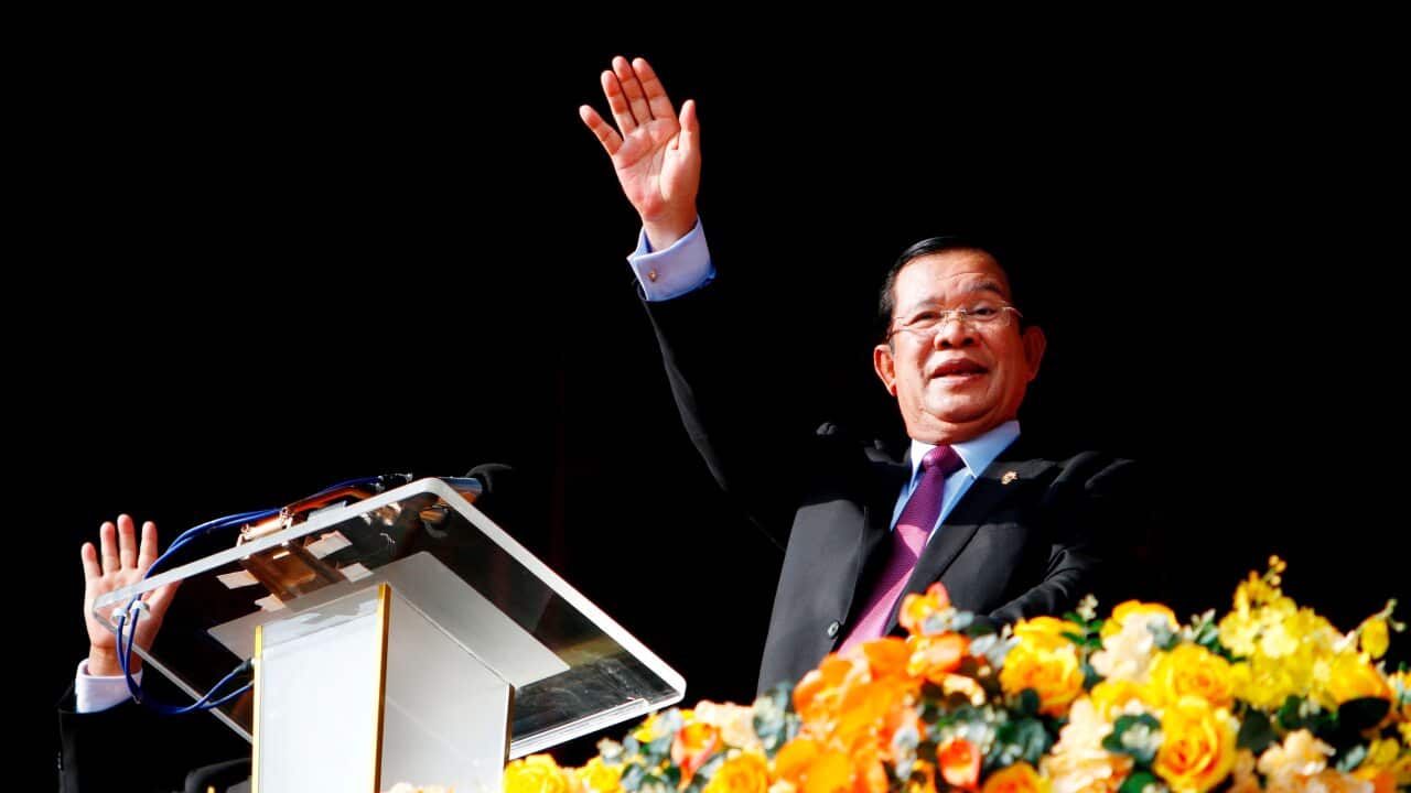 Cambodian Prime Minister Hun Sen waves to the crowd in Phnom Penh during an event commemorating the 40th anniversary of the downfall of the Khmer Rouge regime.