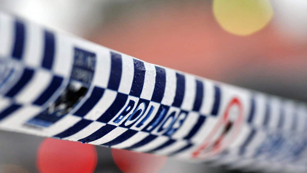 Police tape restricts access to a crime scene