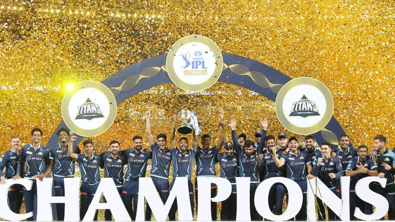 Gujarat Titans players with the IPL trophy.