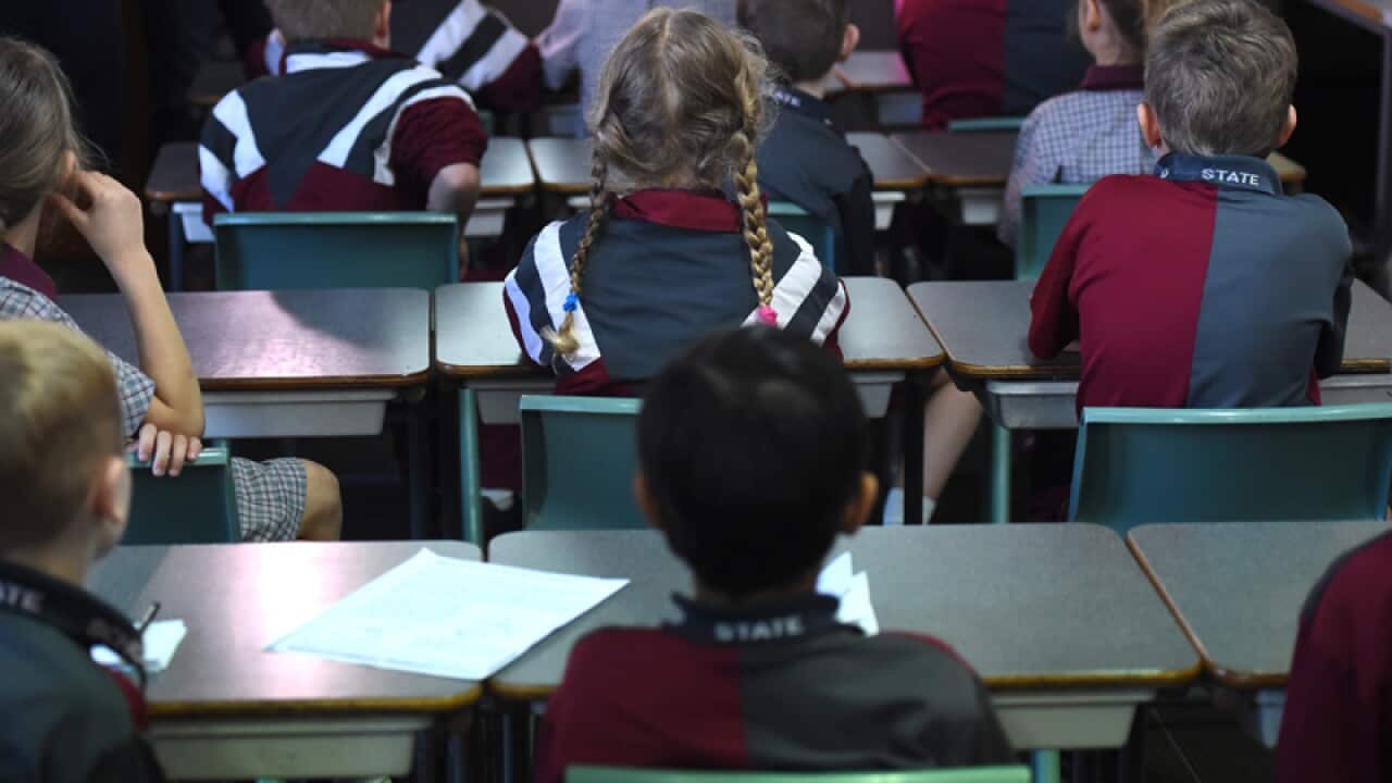 Children sit in a classroom