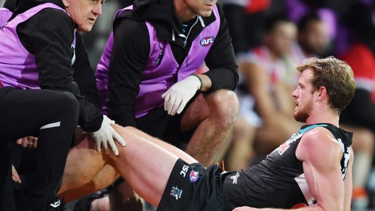 Tom Jonas of the Power has his leg checked.
