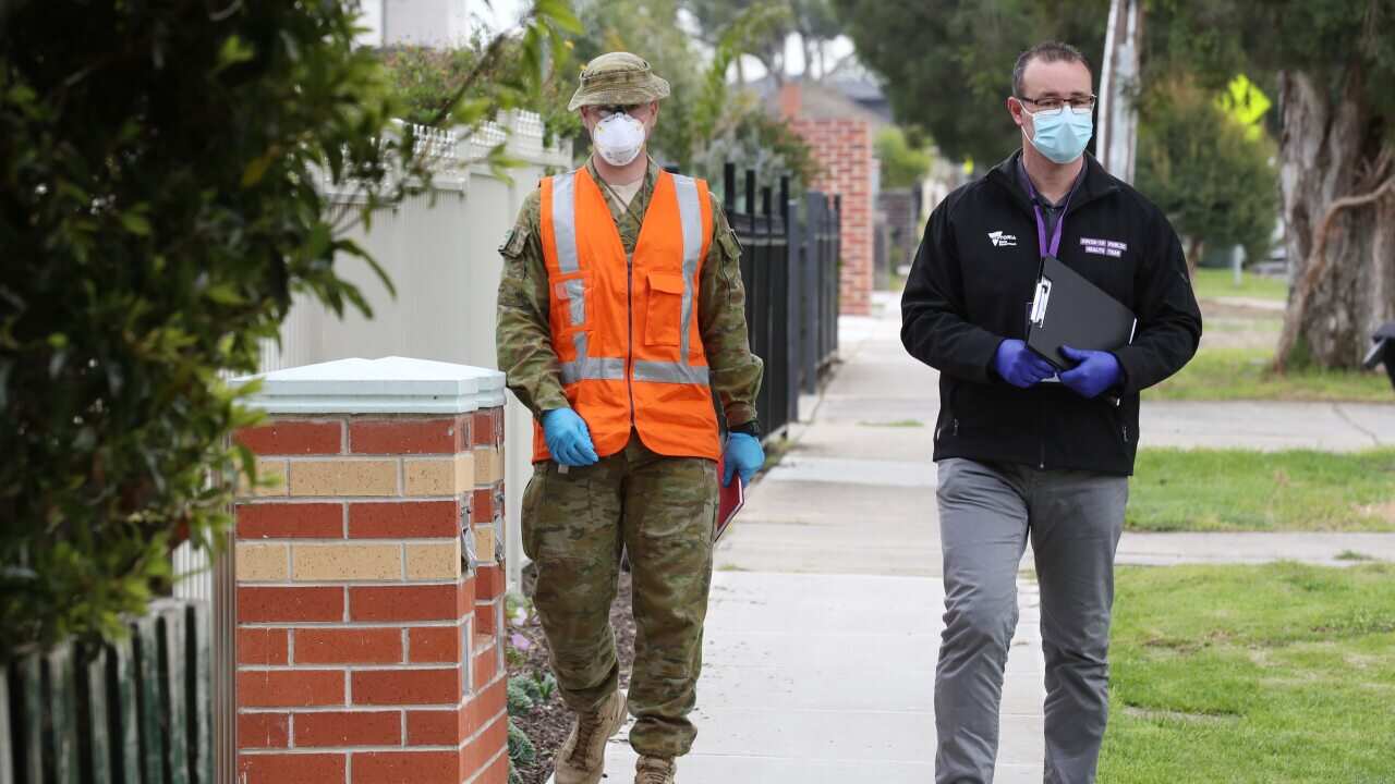 ADF personnel and public health officials doorknocking houses in St Albans.