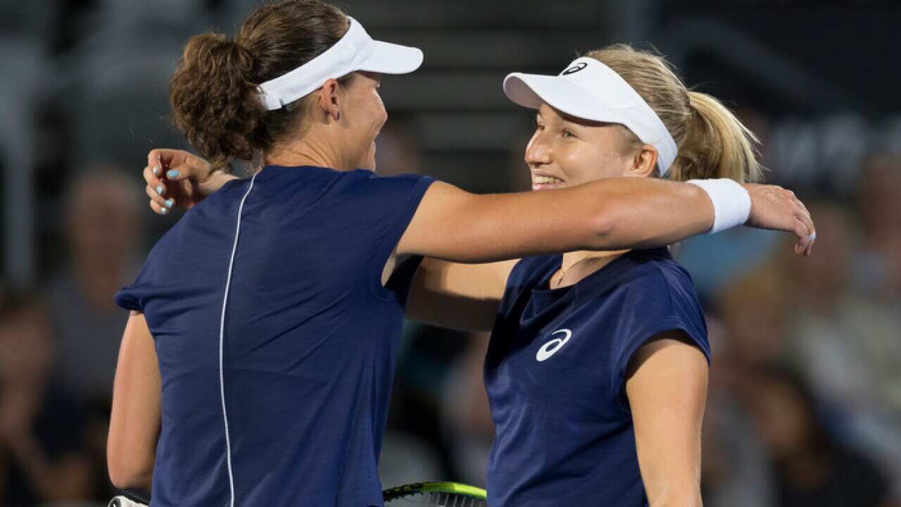 Daria Gavrilova of Australia (right) hugs compatriot Samantha Stosur after their match during the Sydney International Tennis Tournament
