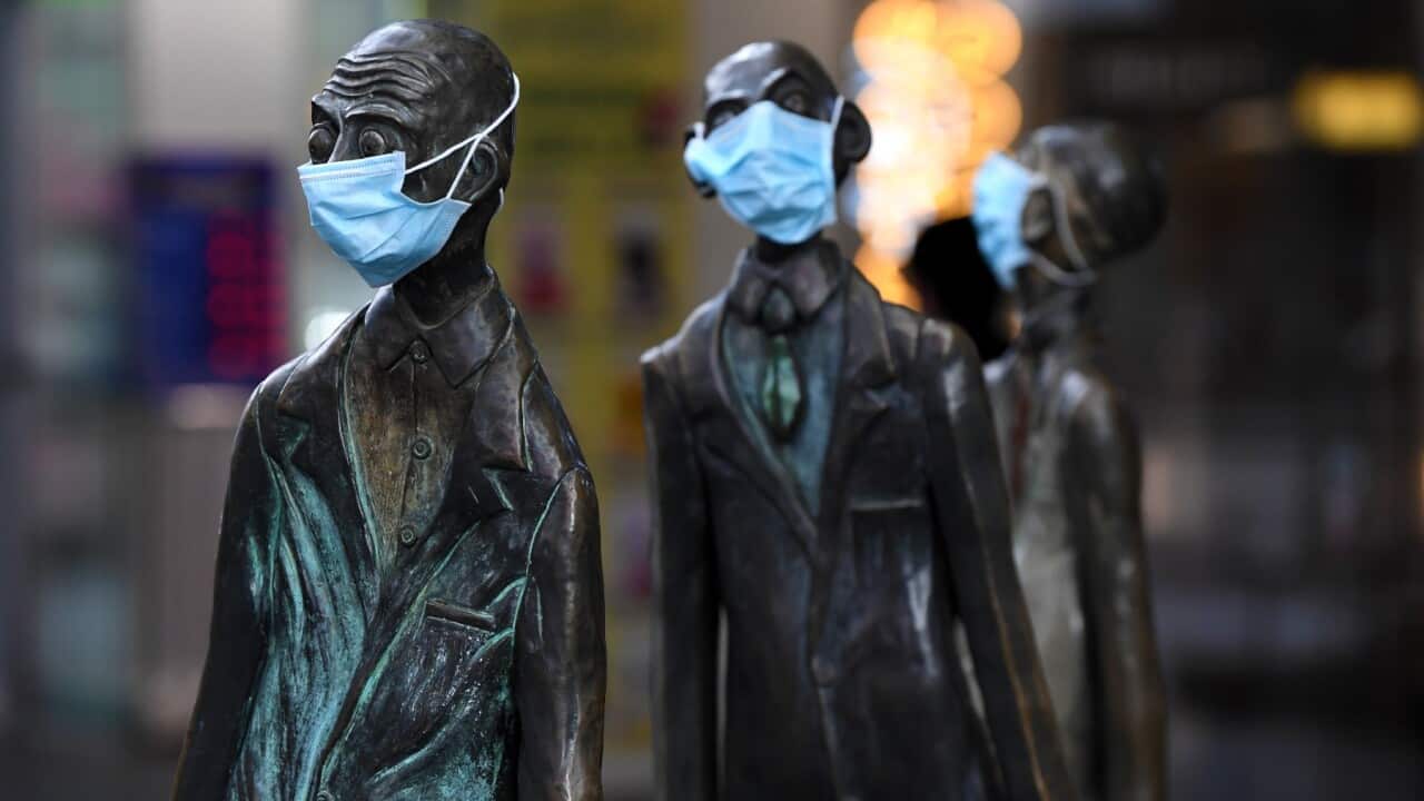 Masks are seen on a statue along Swanston street in Melbourne, Monday, July 20, 2020.