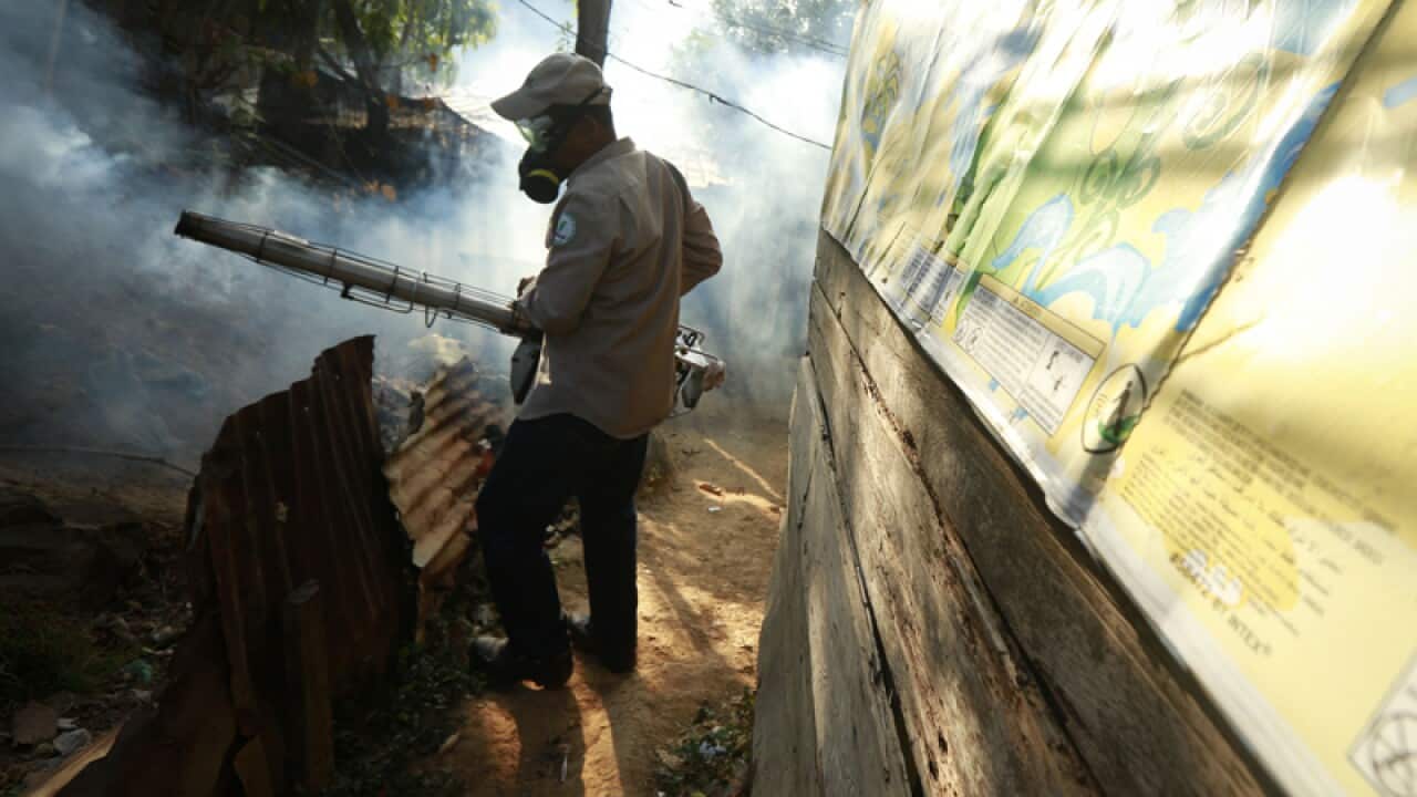 A health ministry worker fumigates an area in Panama