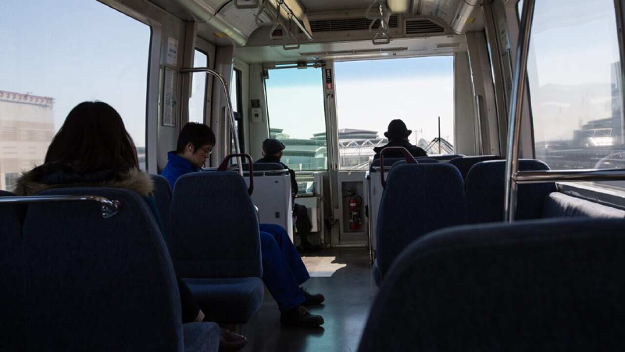 Passengers ride a train in Tokyo, Japan.
