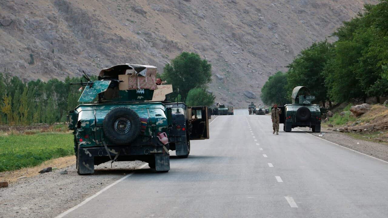 Afghan soldiers pause on a road at the front line of fighting between Taliban and Security forces, near the city of Badakhshan, northern Afghanistan.