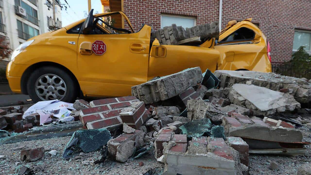 Debris from a collapsed wall is scattered in front of a kindergarten after an earthquake in Pohang, South Korea, Wednesday, November 15, 2017.