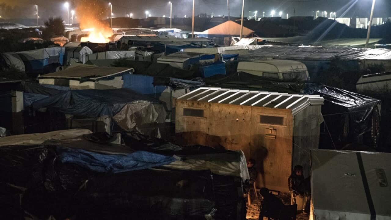 A large firelit in the makeshift camp 'the Jungle'