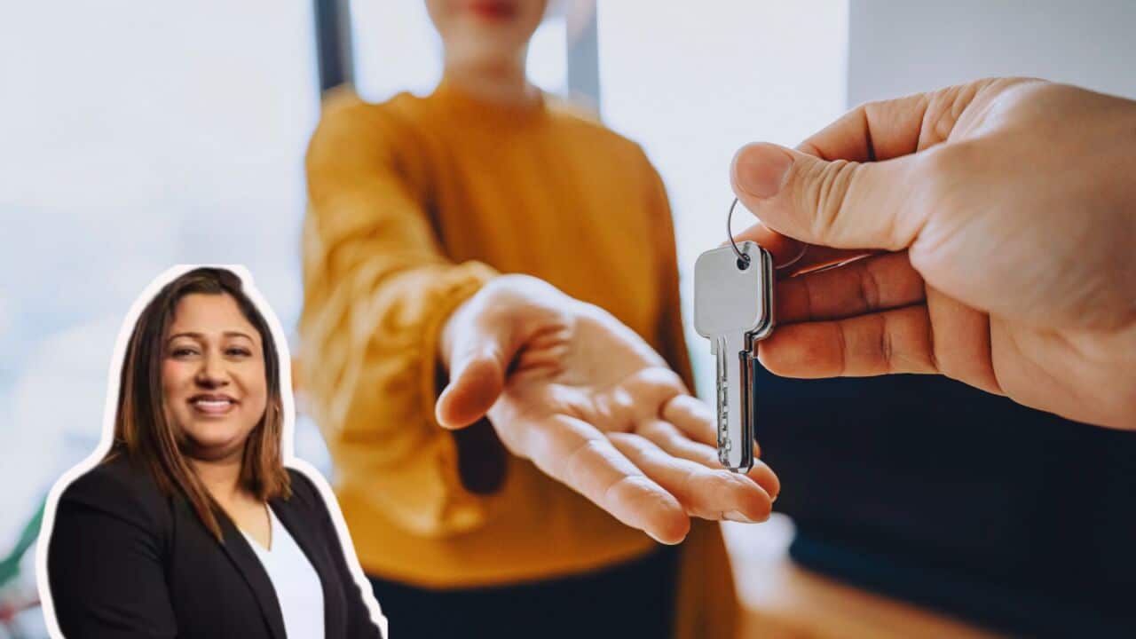 Close-up shot of a real estate agent giving a young Asian woman the keys to her new home. Home ownerships concepts