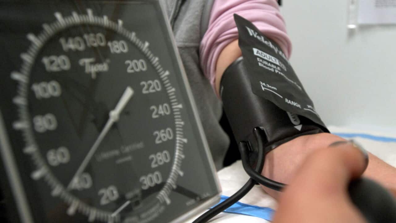 A patient has her blood pressure checked in Canberra
