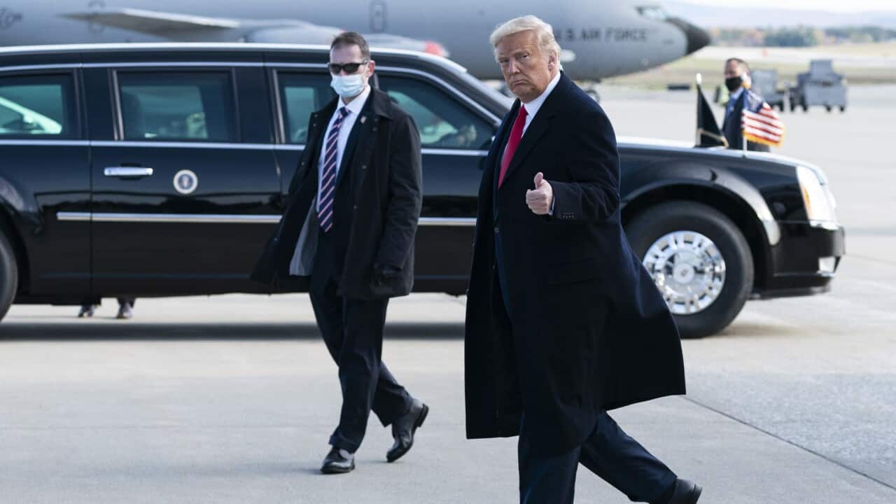 President Donald Trump waves as he steps off Air Force One at Bangor International Airport, Sunday, Oct. 25, 2020, in Bangor, Maine.(AP Photo/Alex Brandon)