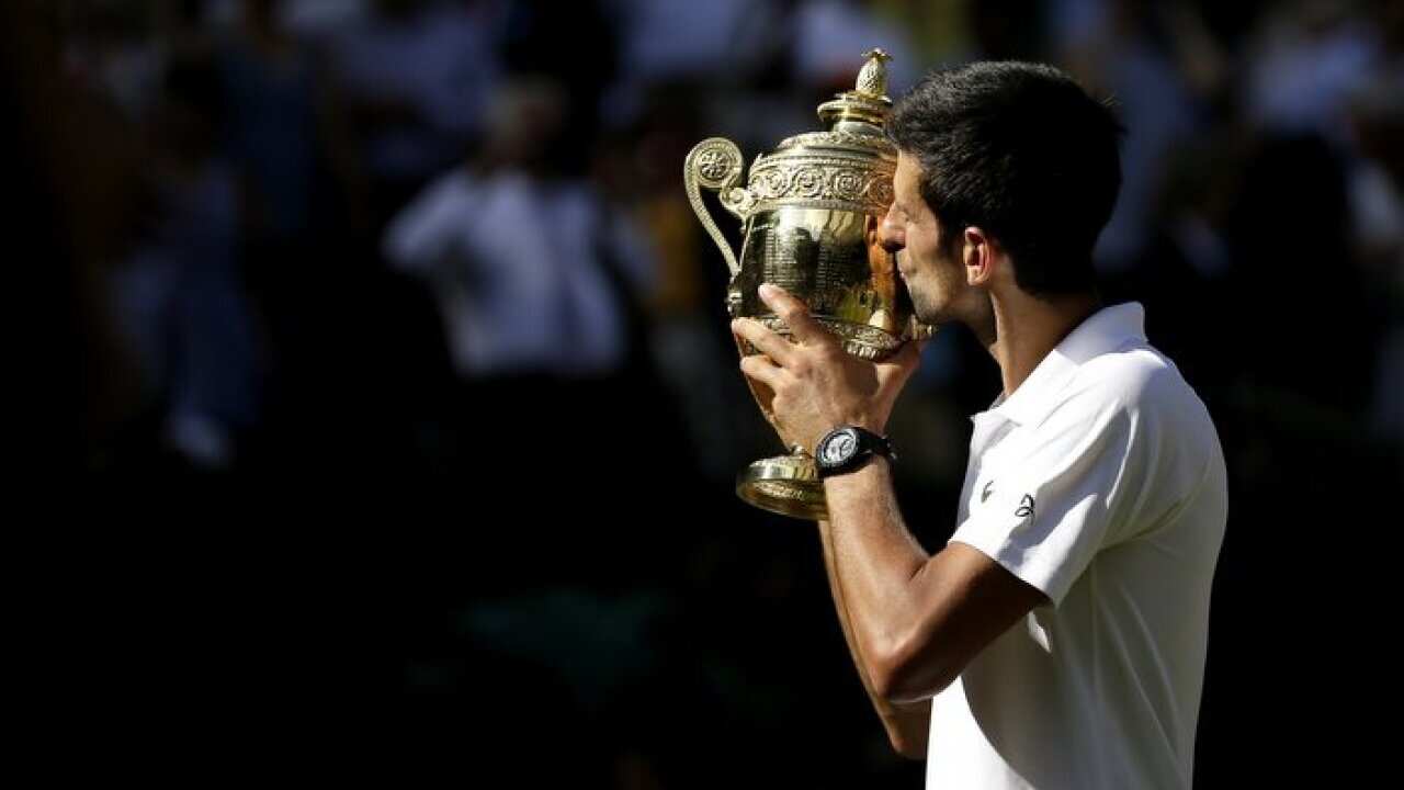 Novak Djokovic with the trophy after winning the Gentlemen's Singles Final against Kevin Anderson on day thirteen of the Wimbledon Championships