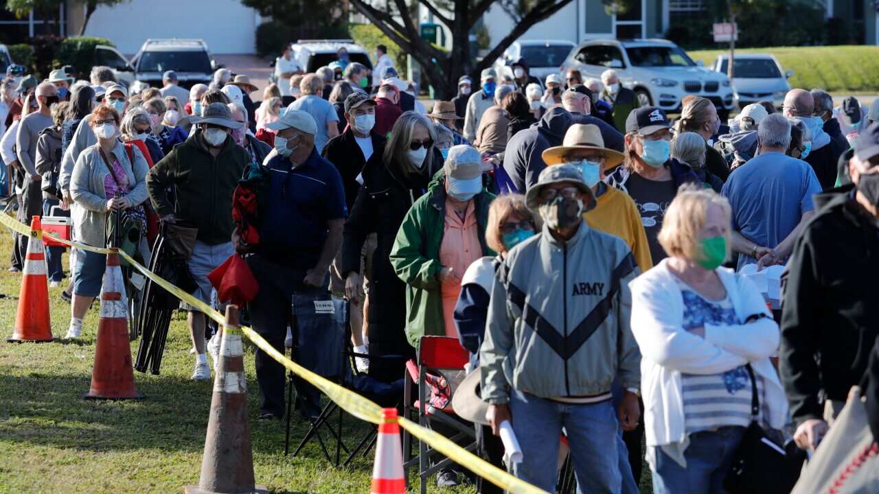 Residents of Florida's Cape Coral wait in line to receive a COVID-19 vaccine 30 December, 2020.