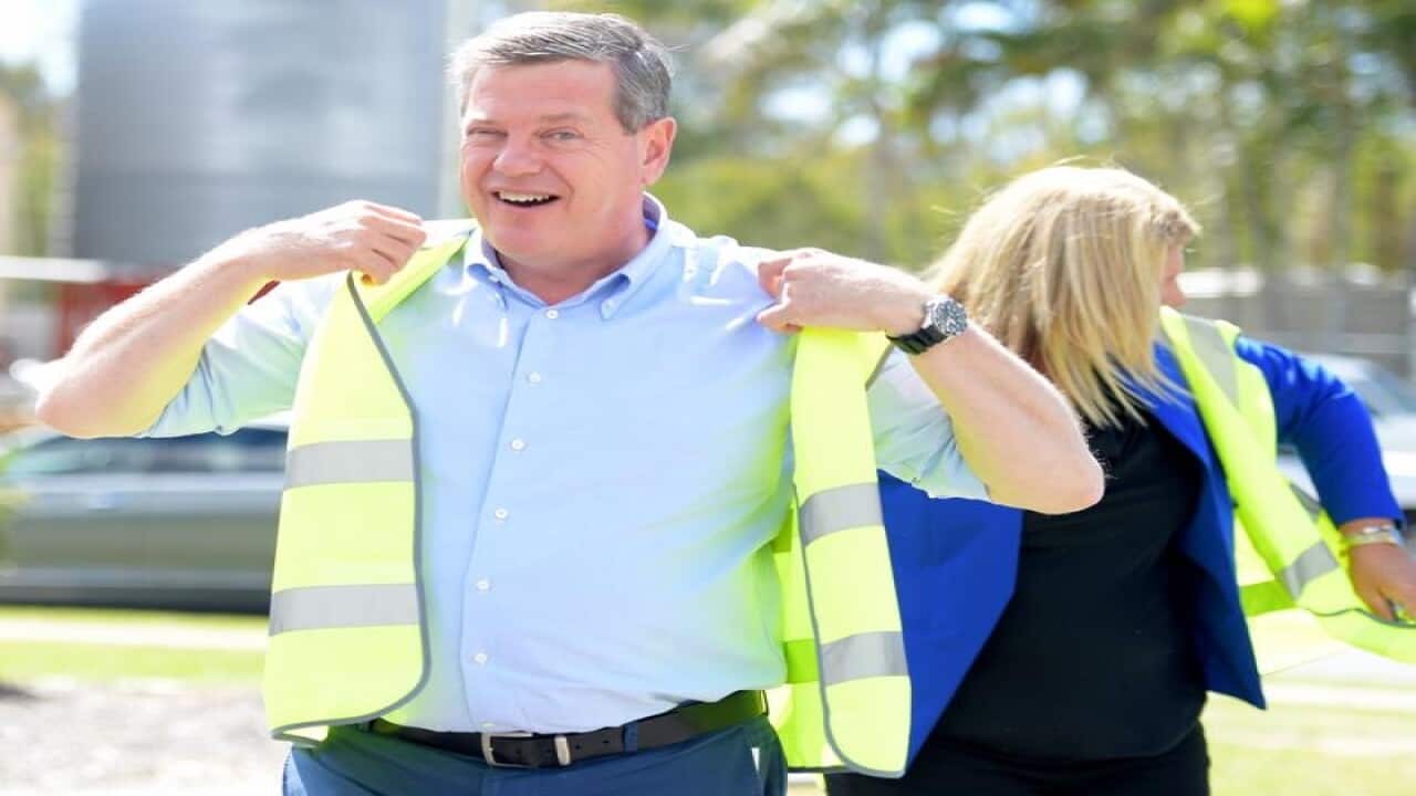Queensland Opposition Leader Tim Nicholls putting on PPE
