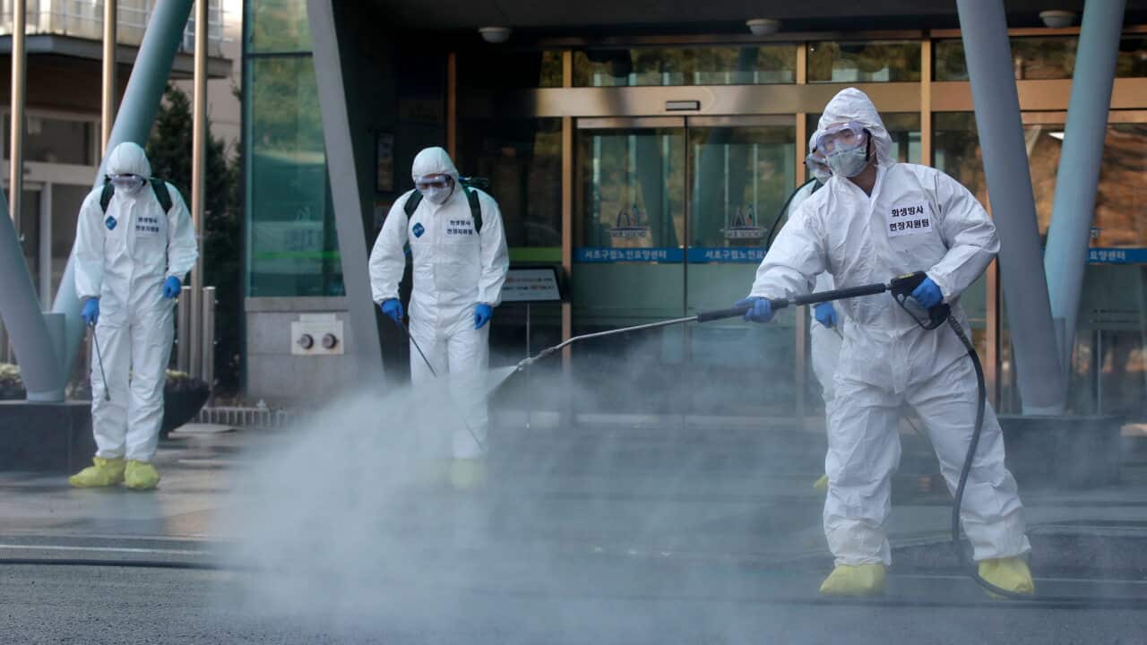 South Korean soldiers wearing protective gears spray disinfectant as a precaution against the new coronavirus in Seoul