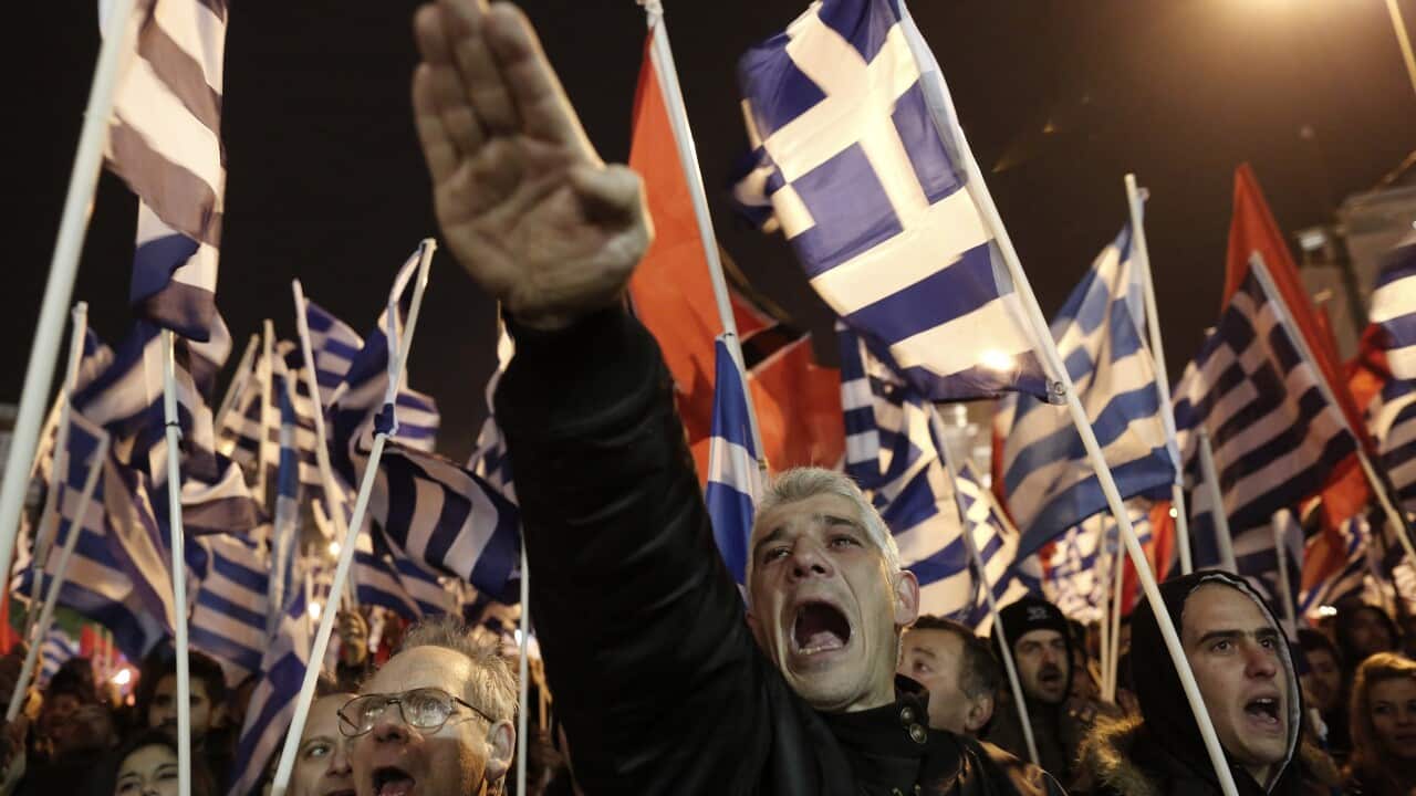 A supporter of Greece's extreme right party Golden Dawn raises his hand in a Nazi-style salute during a rally in Athens on Saturday.