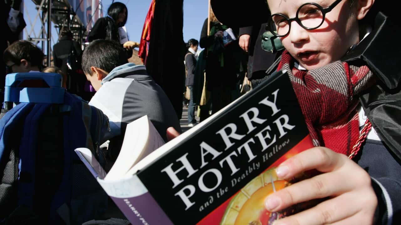 Fans rush to read the opening lines of 'Harry Potter and the Deathly Hallows' during a fans day at The Carriage Works on July 21, 2007. (File: AAP)
