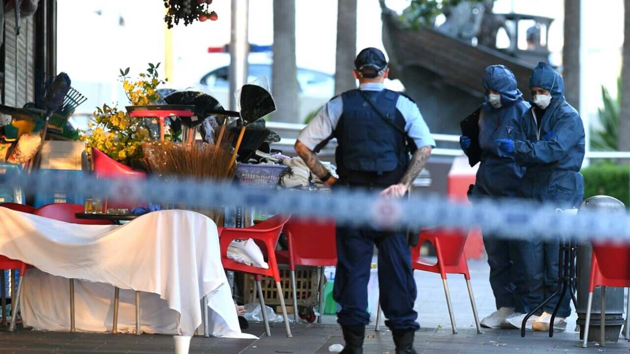 NSW Police and Forensic Services officers attend the scene of a shooting at a cafe at Bankstown City Plaza, in Bankstown, Tuesday, January 23, 2018 (AAP)