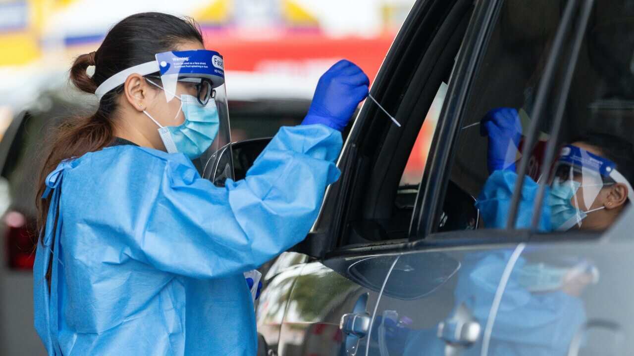 Medical staff are seen working at a drive-through Covid-19 testing clinic