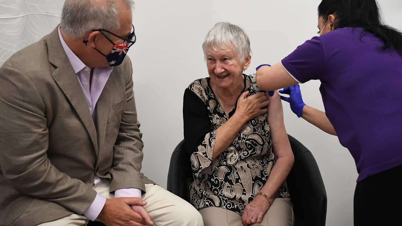 Australian Prime Minister Scott Morrison joins Aged care resident Jane Malysiak (left) as she receives the first Codid-19 vaccine in Australia