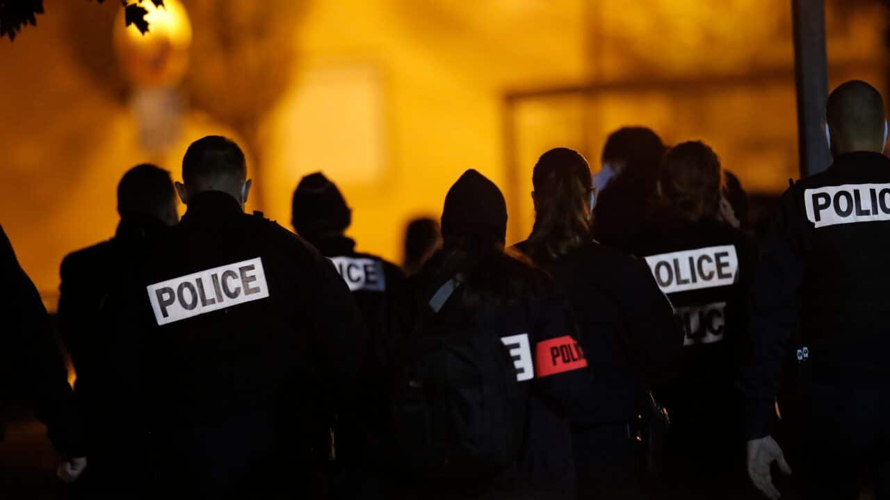 French police officers gather outside the high school