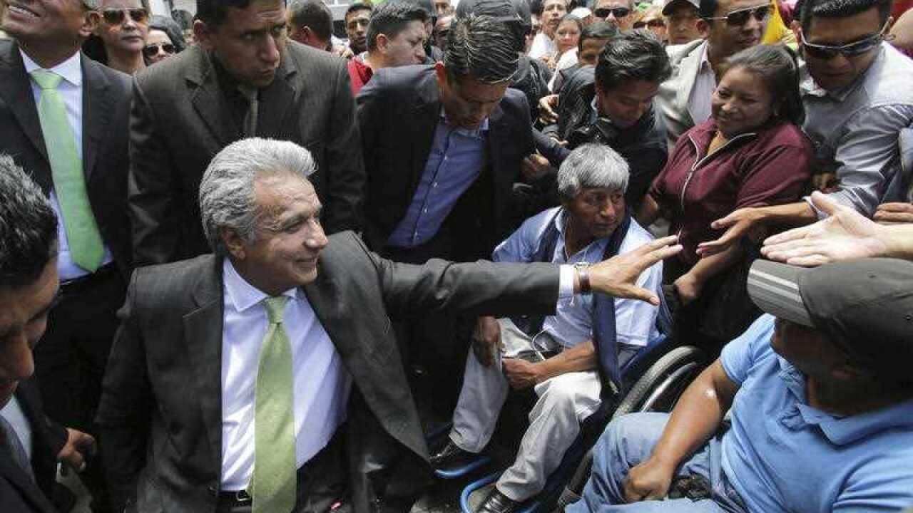 Presidential candidate Lenin Moreno of ruling party Alianza Pais, sitting in a wheelchair, greets supporters at the government palace in Quito, Ecuador