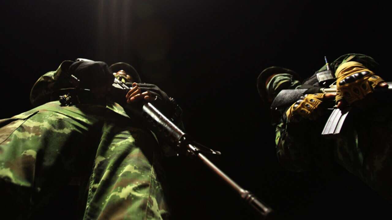 Thai soldiers stand guard near the Democracy Monument