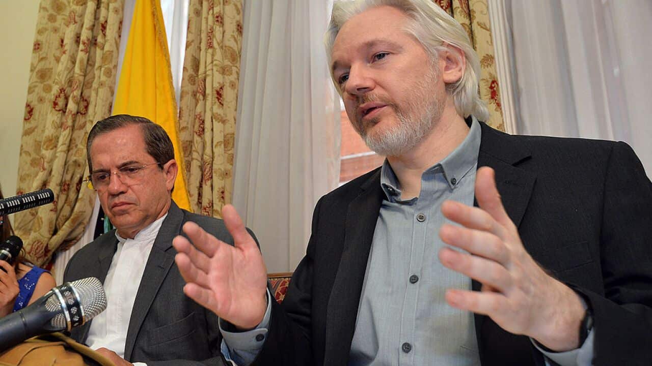 WikiLeaks founder Julian Assange sits next to Ecuadorian Foreign Minister Ricardo Patino during a press conference